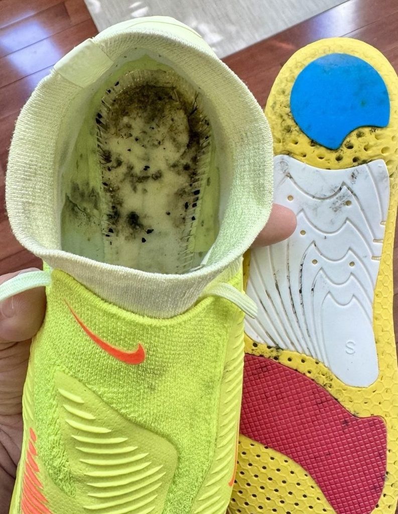 Mildew inside a soccer cleat and on the underside of the removable insole